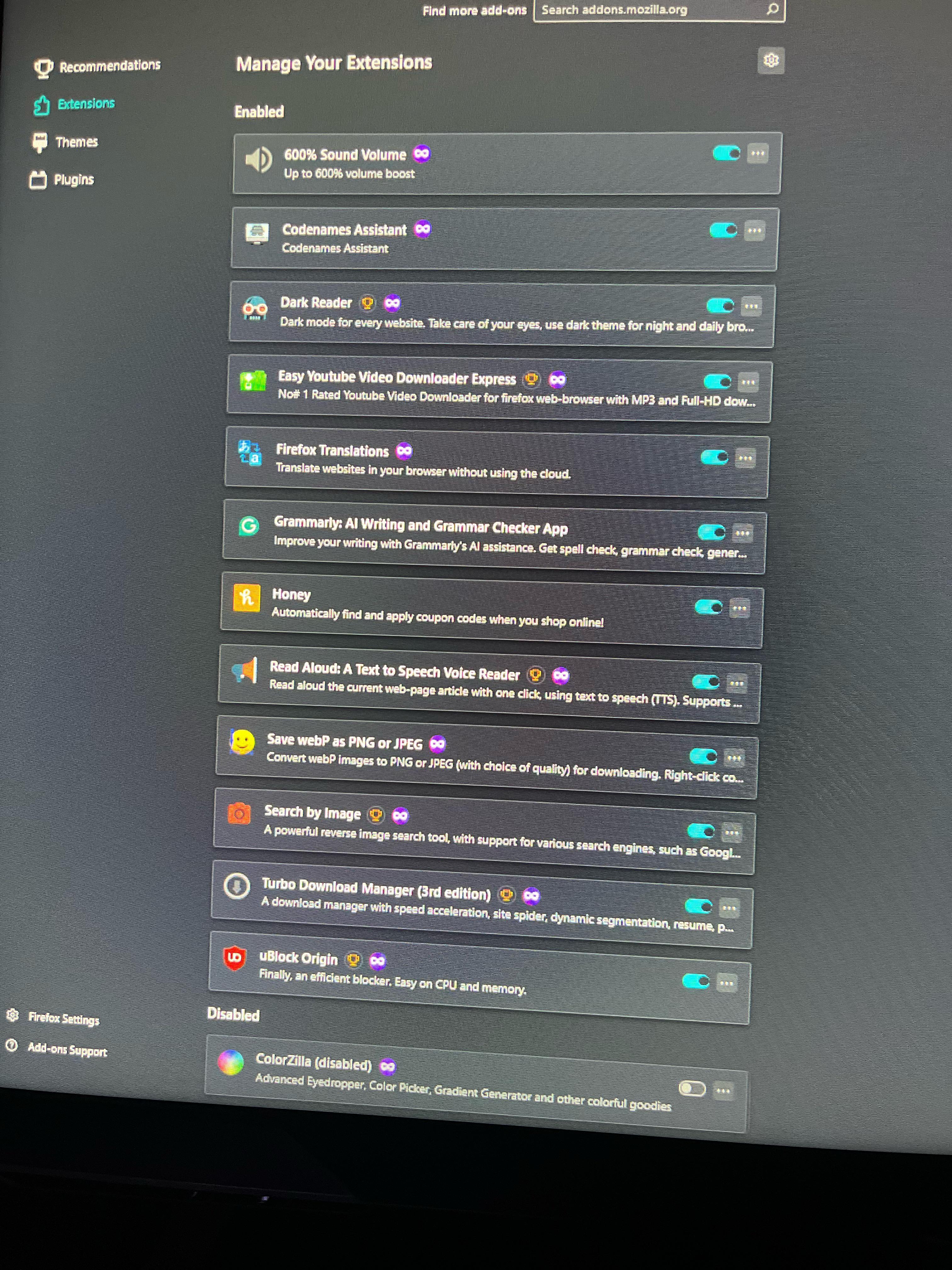 the reddit OP's photo a picture from a reddit post detailing firefox performance issues when loading youtube. it is a photograph of their firefox browser extension settings menu. they have twelve extensions enabled, some of which are known to be resource intensive.